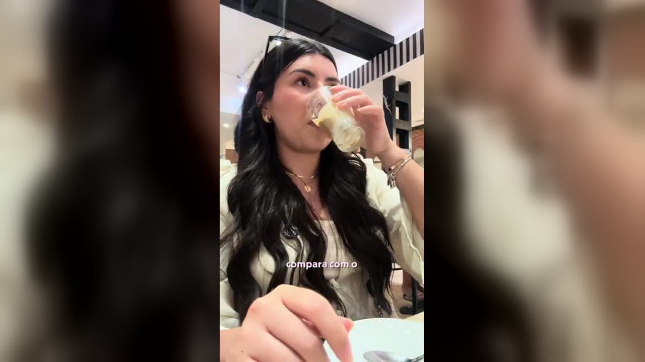 Karol Barbosa provando o café bombón espanhol, com camada de leite condensado e café expresso